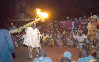 Naa Bohagu Abdulai Mahami Sheriga, Overlord of the Mamprugu Traditional Area lighting the thatch to signify the commencement of the festival